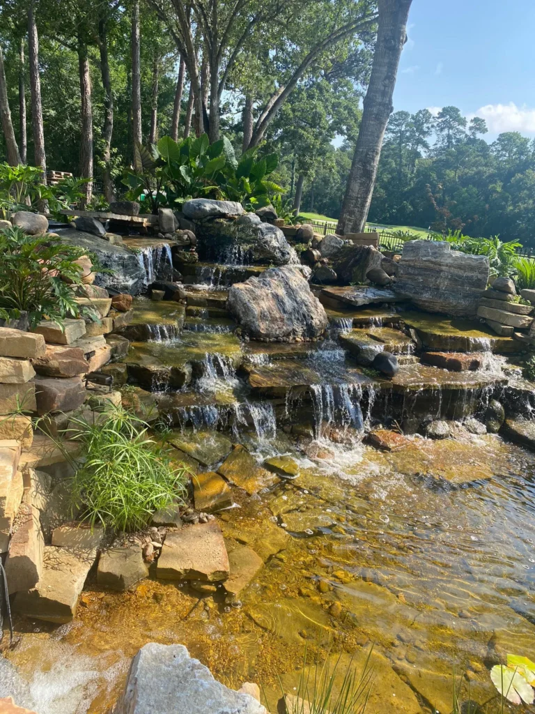 backyard pool with waterfall and slide
