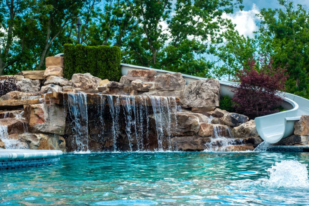 Read more about the article How to Design the Perfect Backyard Pool with Waterfall and Slide Features